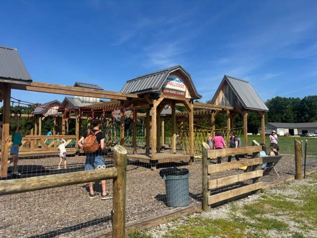 Children playing on the Blooms & Berries low ropes course