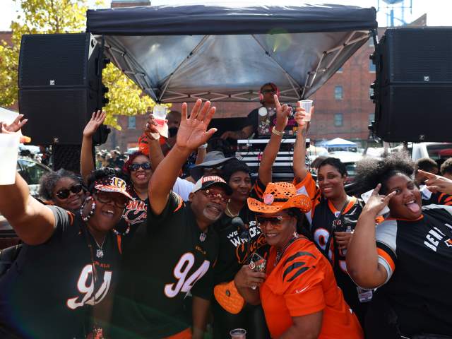 A group of Bengals fans tailgate outside of Longworth Hall before a game.