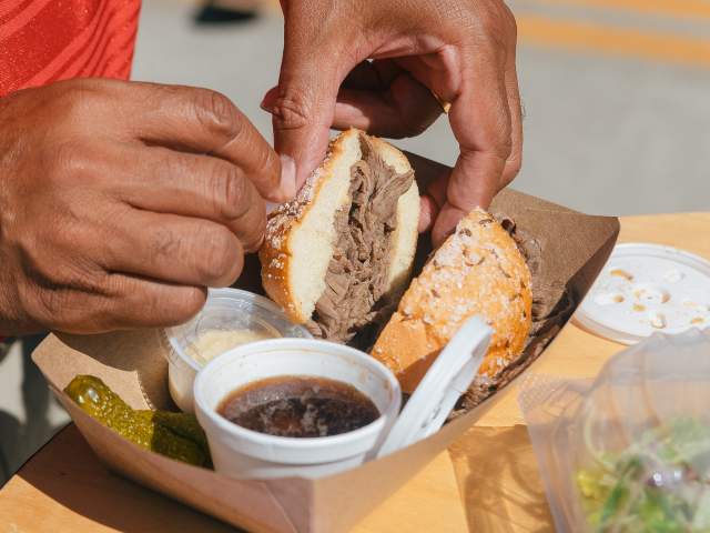 A man at Taste of Cincinnati holds a sandwich