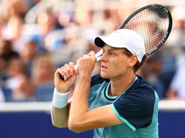 Jannik Sinner, champion tennis player, stands ready for action.