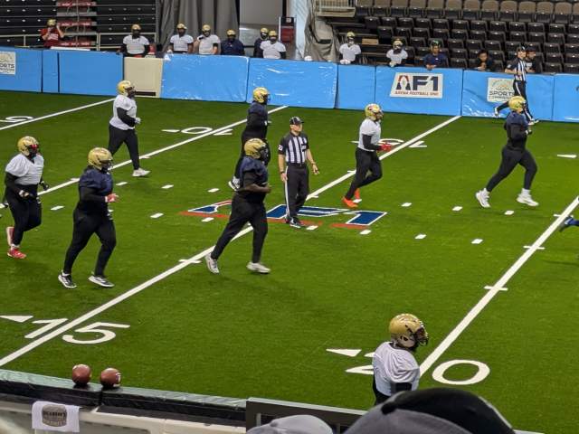 Arena football players play a scrimmage game at practice.