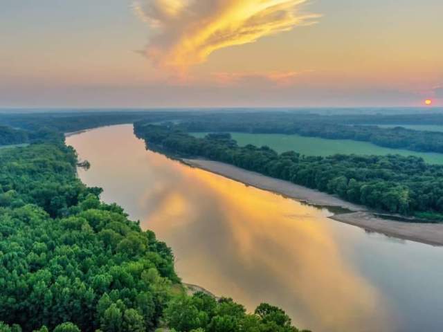 A rural strip of the Ohio River, illuminated during golden hour