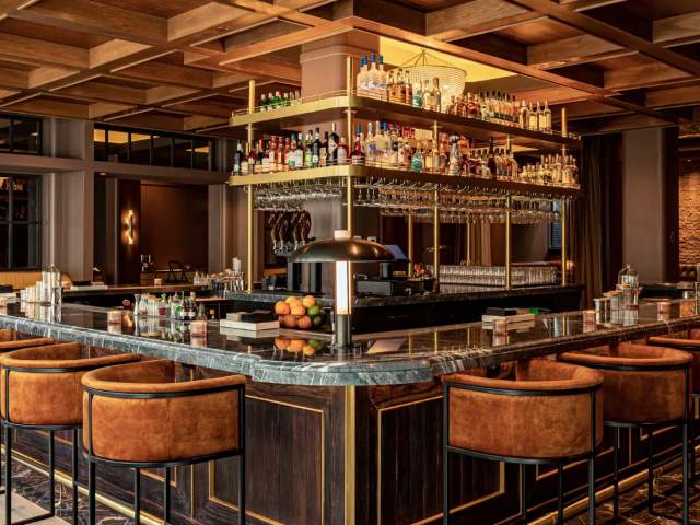 An empty bar with lush seats and ambient lighting