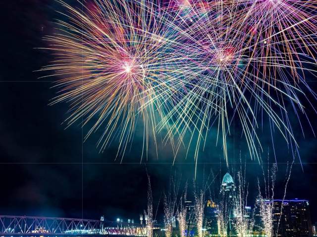 Image is of fireworks over the Ohio River with the City of Cincinnati in the background.