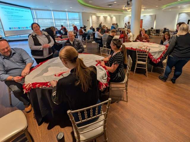 Groups of volunteers helping at a voluntourism event at the Newport Aquarium.