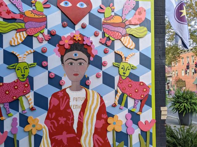 Mural designed like a multi-colored quilt with a portrait of Frida Kahlo in the center