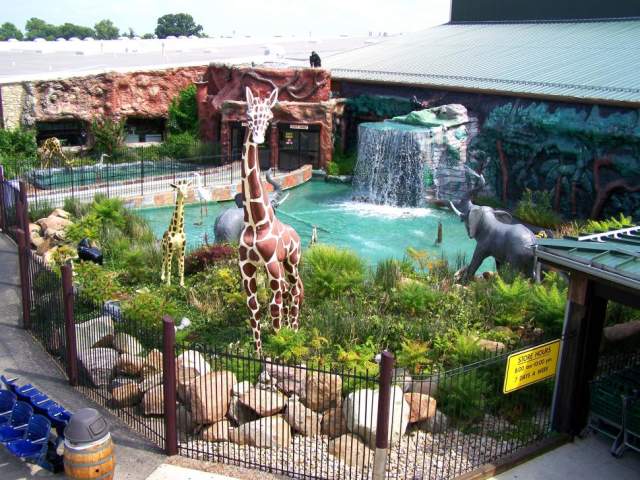 Exterior of Jungle Jim's showing life-sized fiberglass animals "playing" around a pool with working waterfall.