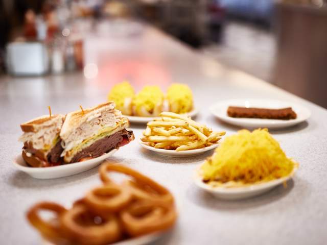 Full spread of food including double deckers, fries and coneys at Camp Washington Chili