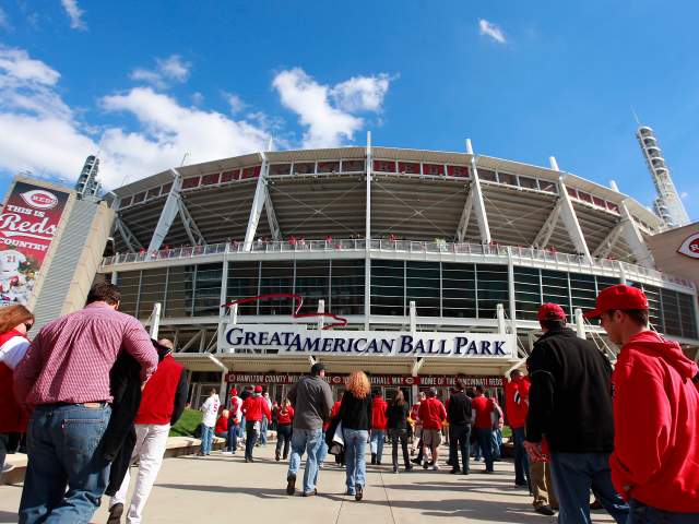 Groups of people walk away from the camera towards the entrance to Great American Ball Park.