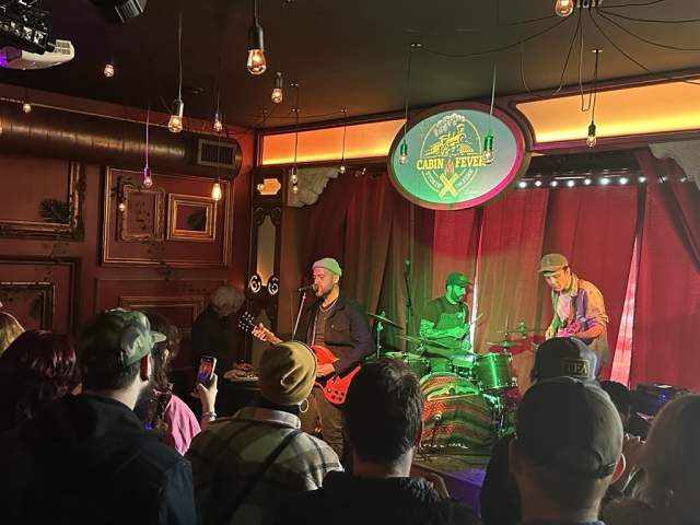 A musical act performs in front of an audience at Cabin Fever Music Festival.