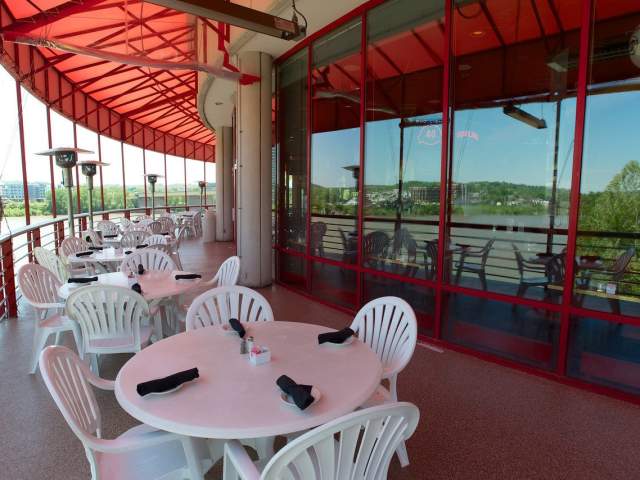 White tables are placed along the curved patio at Montgomery Inn.