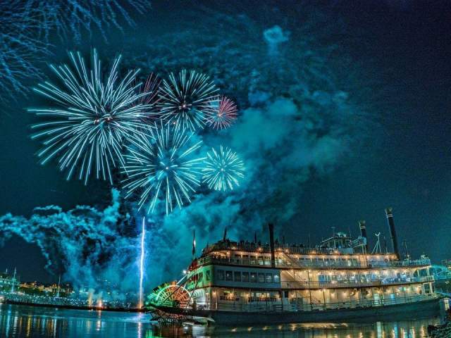 The image is of the BB Riverboat at night with fireworks in the background.