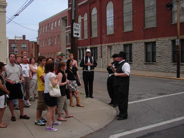 A group of people listen to tour guides.