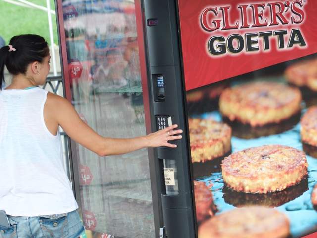 A woman placing an order at the Glier's Goetta Vending Machine
