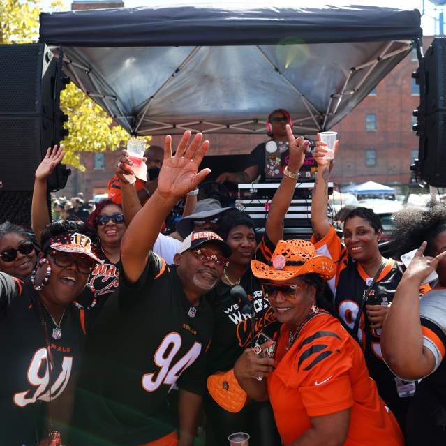 A group of Bengals fans tailgate outside of Longworth Hall before a game.