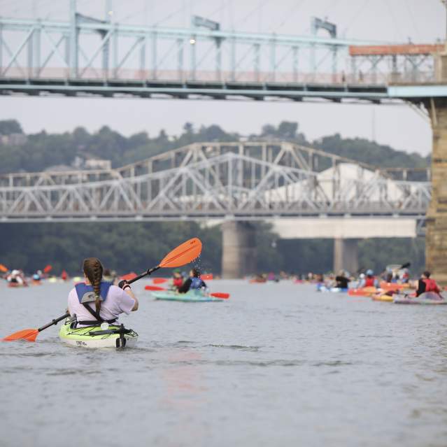 Paddlers cross under several iconic bridges in downtown Cincinnati