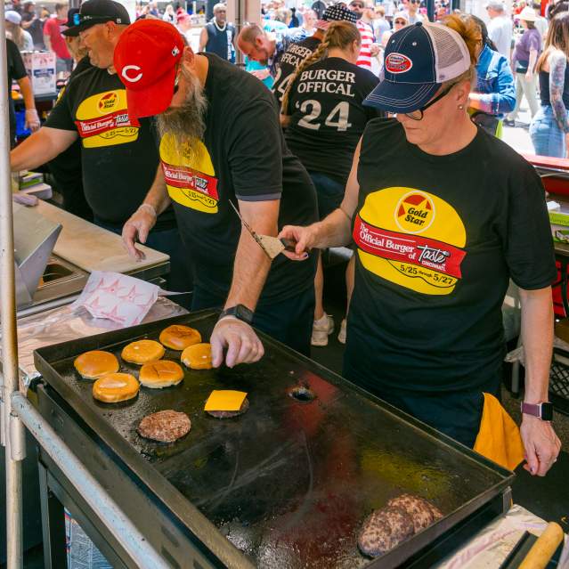 A crew at Taste of Cincinnati grill up some cheeseburgers.