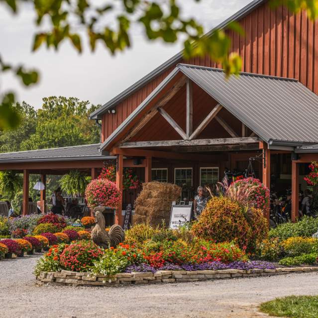 Exterior of a barn with fall foliage and colors