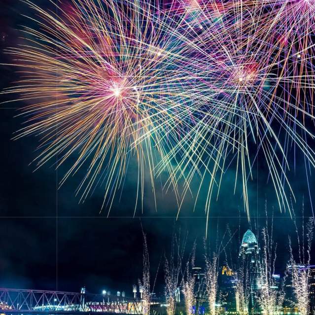 Image is of fireworks over the Ohio River with the City of Cincinnati in the background.