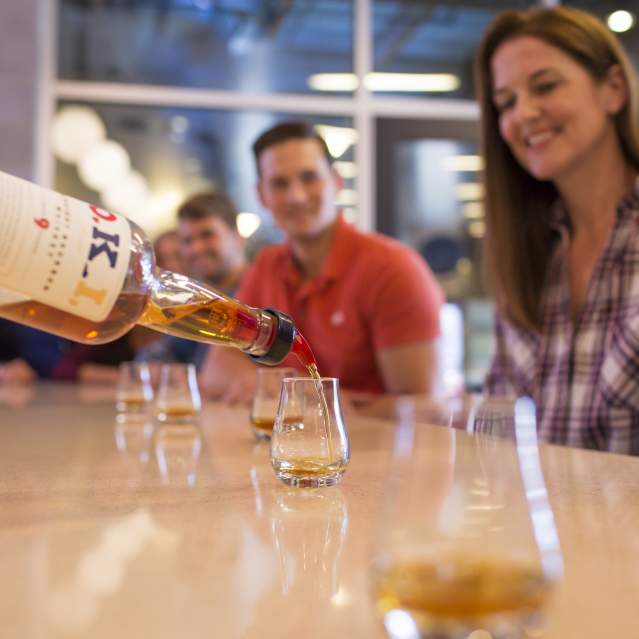 Bourbon being poured at bar