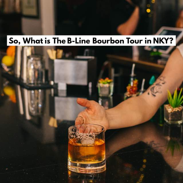 A woman's hand offering an old fashioned on a glossy bar with the words "So, What is The B-Line Bourbon Tour in NKY" printed above.