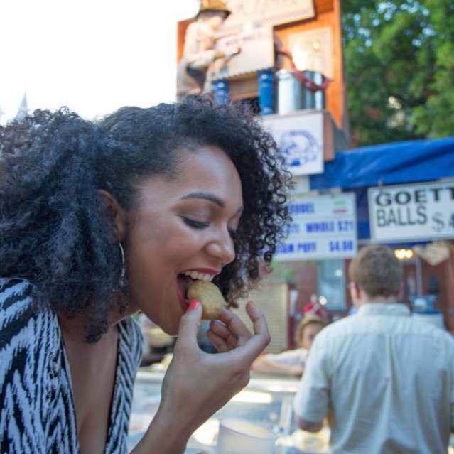 Woman eating goetta balls at a street festival (photo: CincinnatiUSA.com)