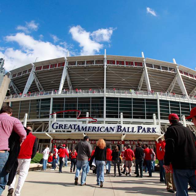Groups of people walk away from the camera towards the entrance to Great American Ball Park.