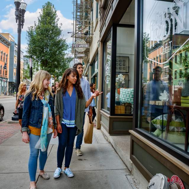 People walking down sidewalk