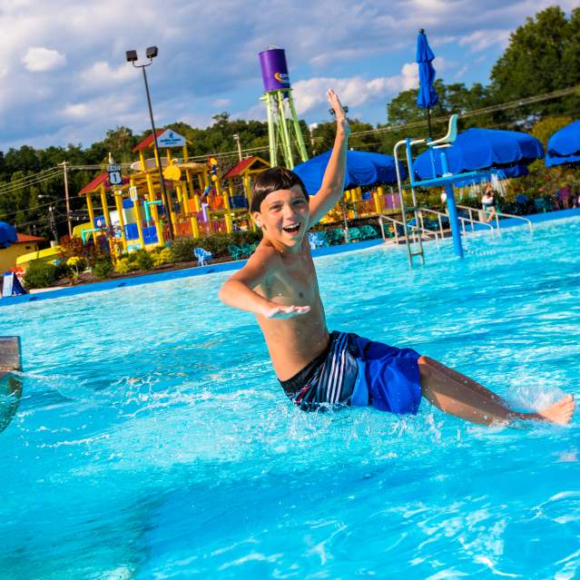young boy having fun splashing around at a pool in Cincinnati