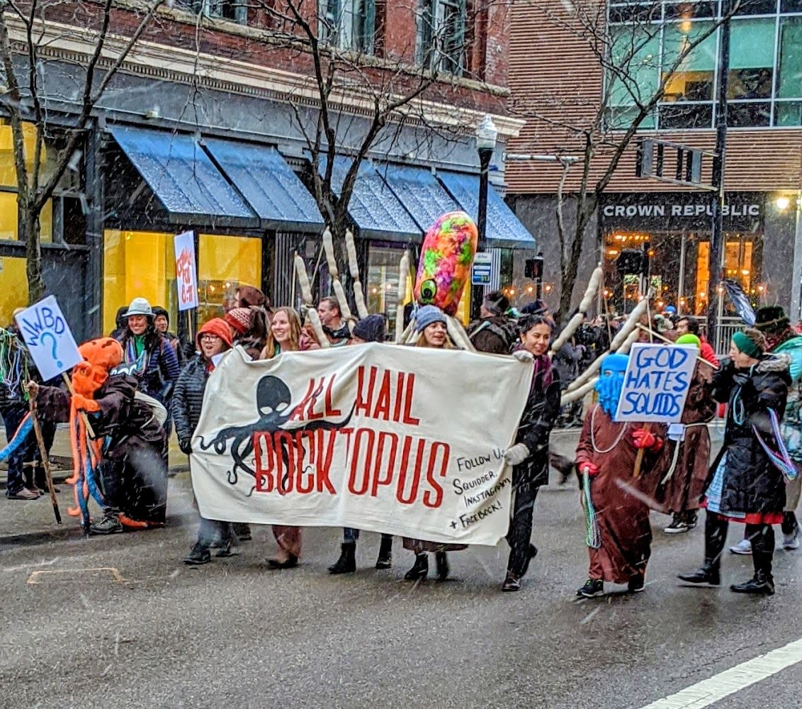 A group holding a banner that reads All Hail Boctopus in the Bockfest parade