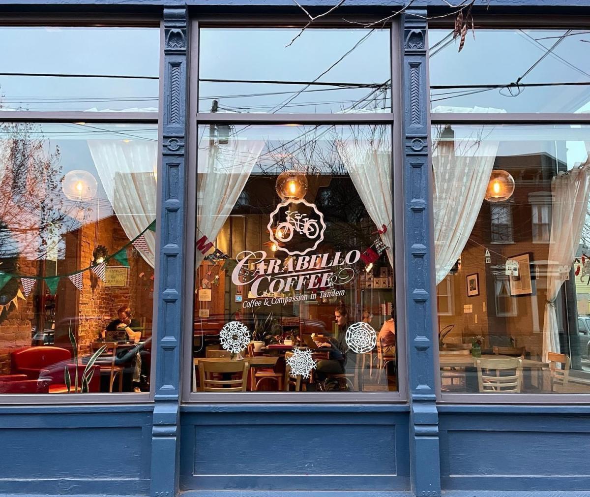 Image is of the outside window of Carabello Coffee with the name "Carabello Coffee" in the window.