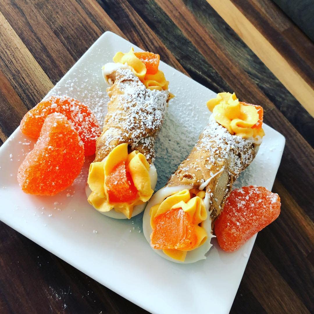 Two cannoli with gumdrops and powdered sugar at Delgardo's in Covington, KY.