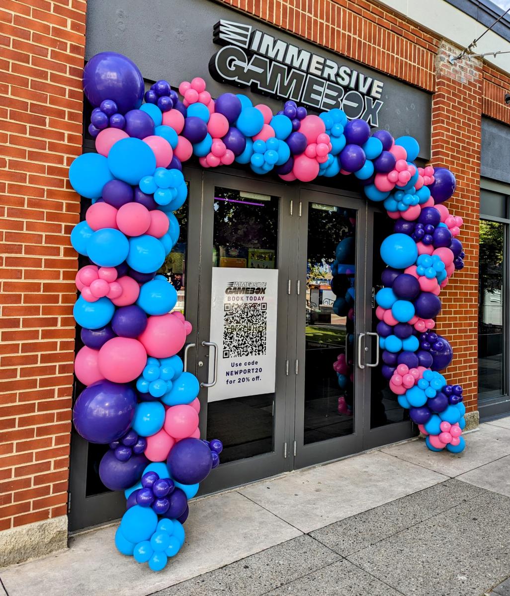 Image is of the front door of Immersive Gamebox with a balloon halo that goes all the way around it.