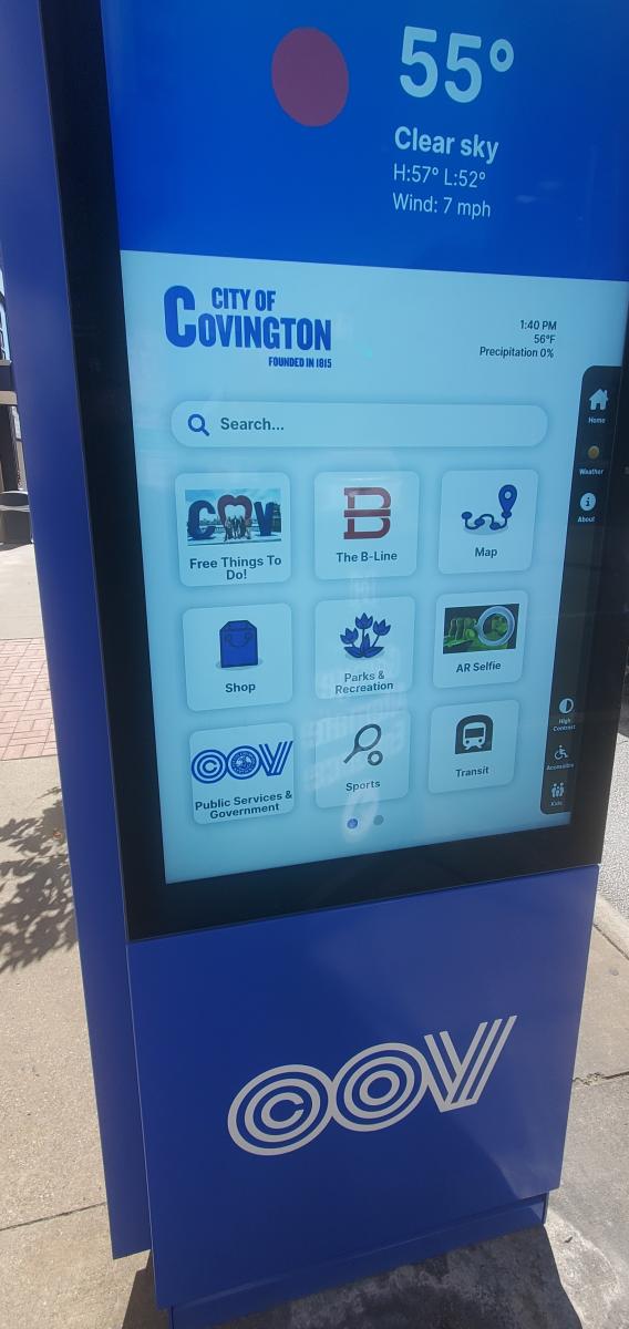 A large blue sign features a touchscreen with navigation apps to help explore Covington, Kentucky