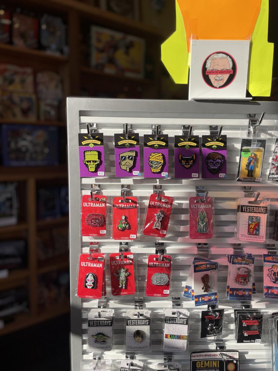 Image is a display of character pins including aliens and Frankenstein.