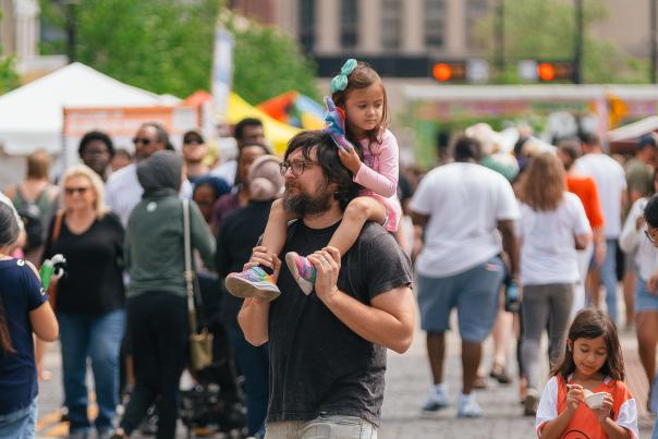 Dad walking with his daughters at Asian Food Fest