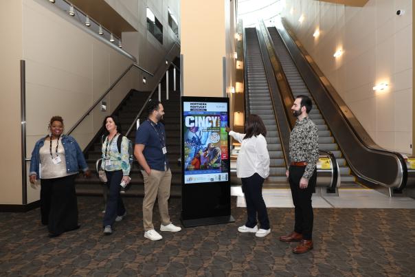 Conference attendees use an interactive kiosk.