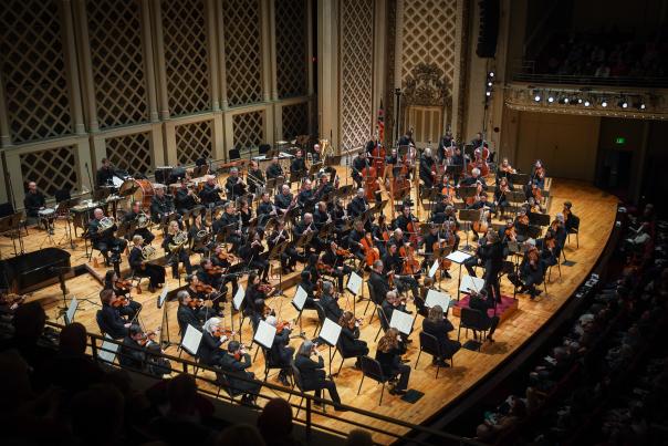 A group of musicians are assembled onstage at the Cincinnati Symphony Orchestra.