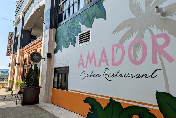 Image is out the outside of Amador with a mural of trees and it say's "Amador Cuban Restaurant".