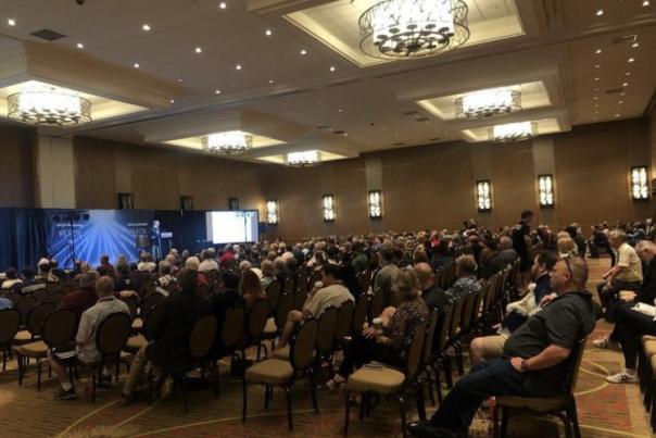 A group gathers in a conference room to learn more about aliens at the MUFON symposium