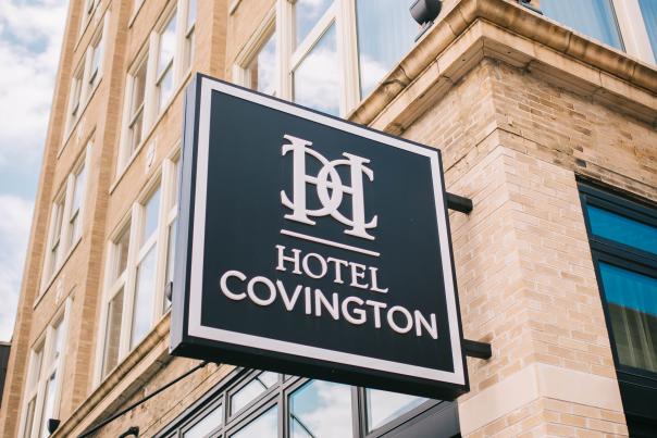 outdoor brick and windows with sign for Hotel Covington on Madison Avenue in covington ky