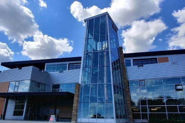 New Riff Distilling's main building, with lots of windows and the three story copper still visible through the main tower.