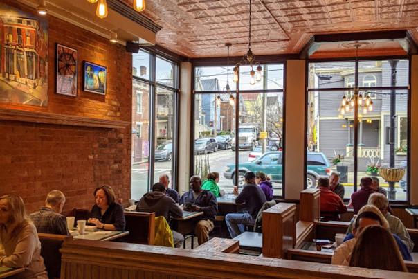 Tin ceiling and large windows and many lunch diners inside Fessler's in Bellevue kentucky