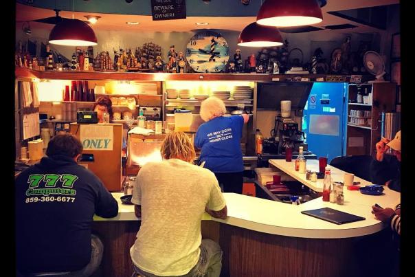 picture of two men sitting on stools in the anchor grill, a diner in covington kentucky