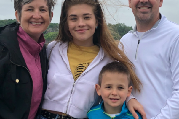 Julie Kirkpatrick, CEO of meetNKY, smiling at the camera with her family