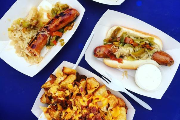 blue background with shot taken above plates of food including german fare from oktoberfest zinzinnati