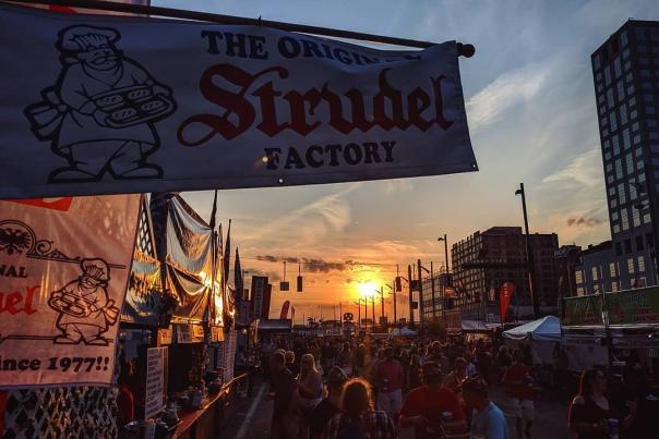 Sunset behind a banner for a Strudel booth at Oktoberfest Zinzinnati