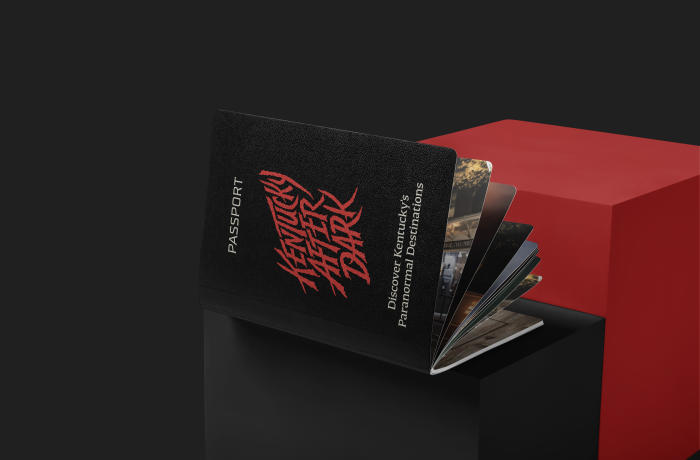 A black booklet sits sideways and open. The text says Kentucky After Dark in red.
