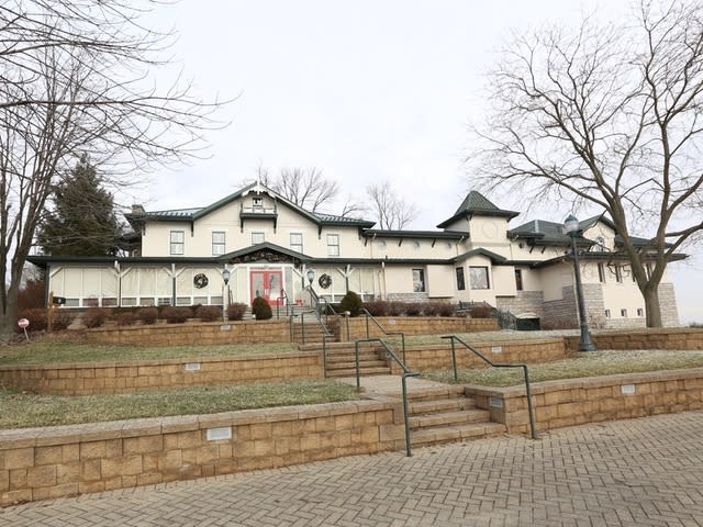 Image is of the Behringer-Crawford Museum building from the front in the winter surrounded by bare trees and a gray sky.