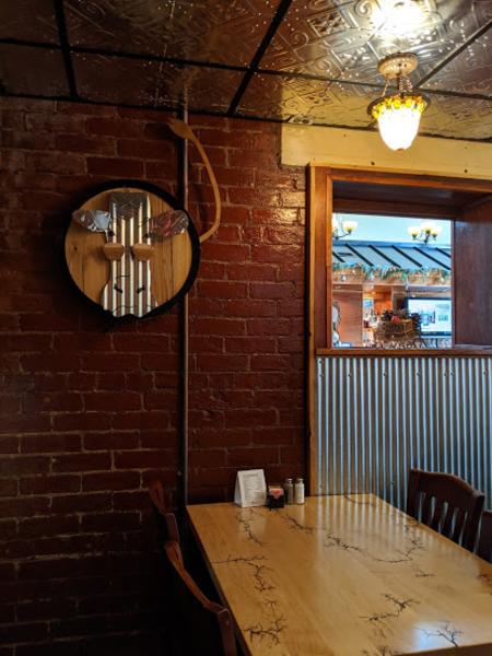 wall at elusive cow restaurant in bellevue ky featuring artwork of the logo